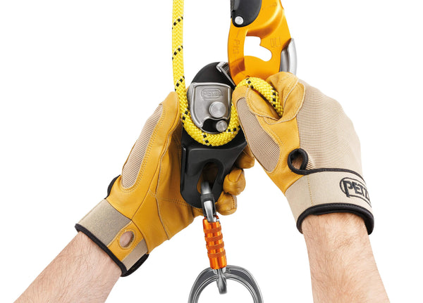 Yellow PETZL RIG Descender with ergonomic handle and AUTO-LOCK system for controlled rope access descents